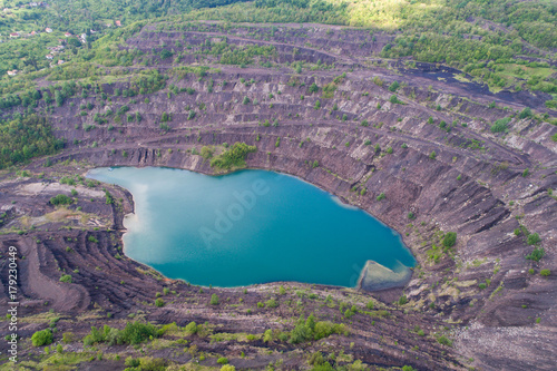 aerial view of deep mine lake in place of the mining pit photo