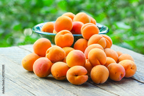 Apricots in the garden on a wooden table