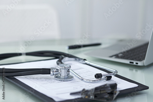 Medicine doctor's working table. Focus on stethoscope 