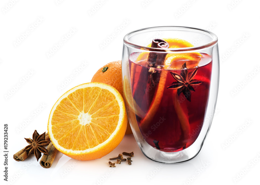 Double wall glass cup with mulled wine, spices, orange, anise and cinnamon sticks isolated on white background. Double wall glass cup with mulled wine, spices, orange, anise and cinnamon sticks isolated on white background.
