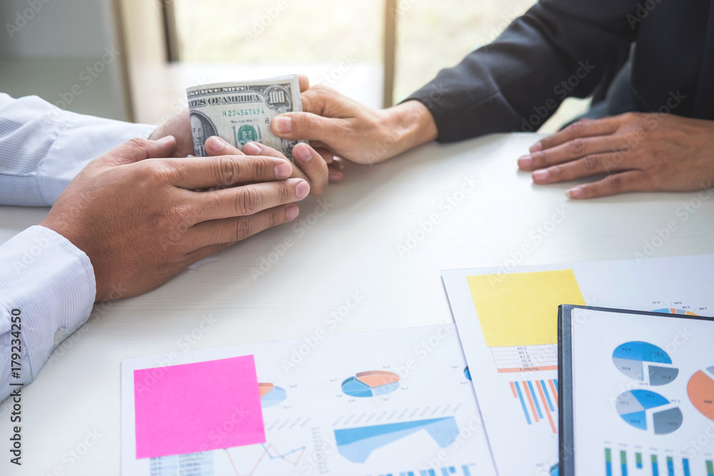 Bribery and corruption concept, bribe in the form of dollar bills, Businessman giving money while making deal to agreement a real estate contract and financial corporate Bribery and corruption concept, bribe in the form of dollar bills, Businessman giving money while making deal to agreement a real estate contract and financial corporate
