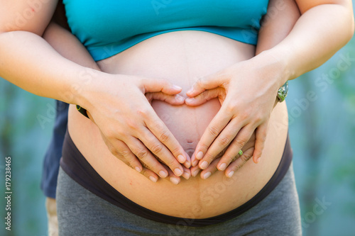 Wallpaper Mural Cropped image of beautiful pregnant woman and her handsome husband hugging the tummy Torontodigital.ca