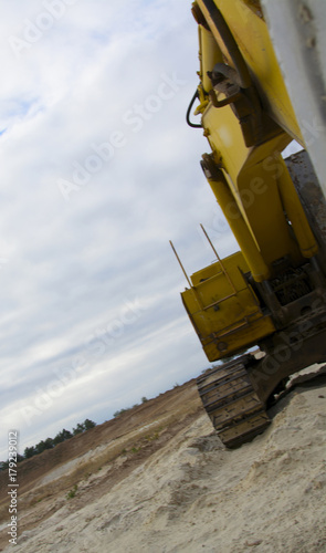 old abandoned yellow excavator in sandpit