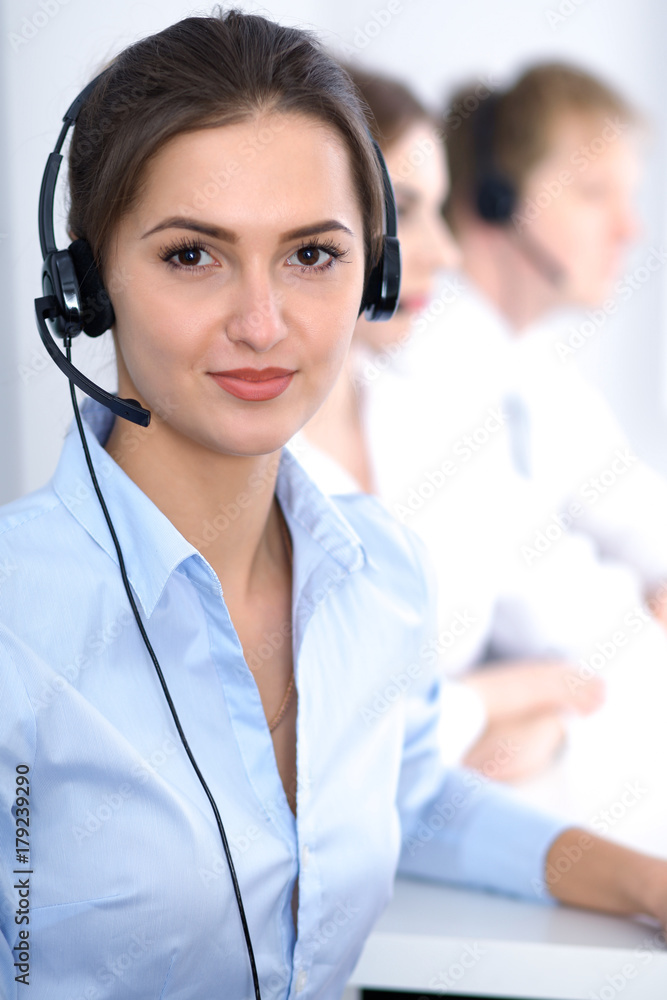 Call center. Focus on beautiful business woman in headset Call center. Focus on beautiful business woman in headset