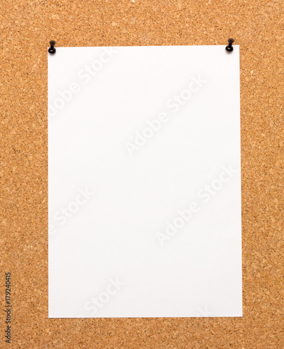 a white sheet pinned on cork Board