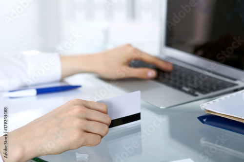Close up of business woman hands typing on laptop computer