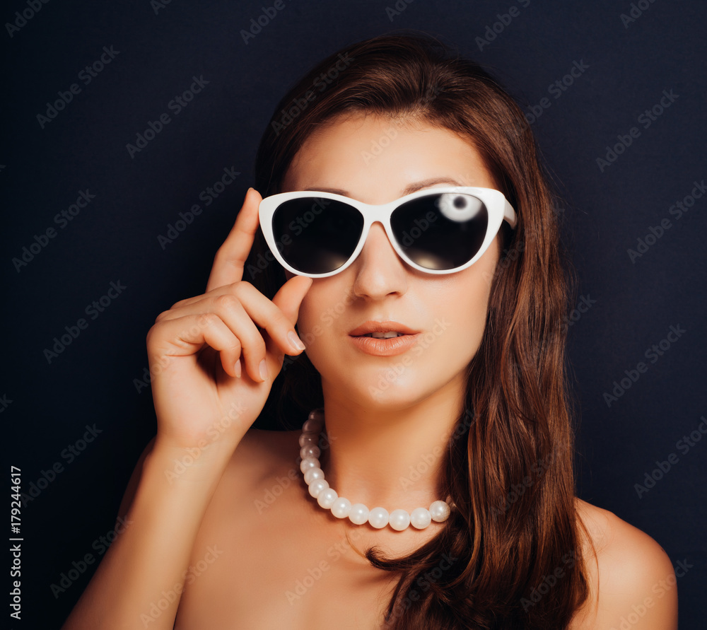 Woman on a dark background close-up with glasses. Pin-up style Woman on a dark background close-up with glasses. Pin-up style
