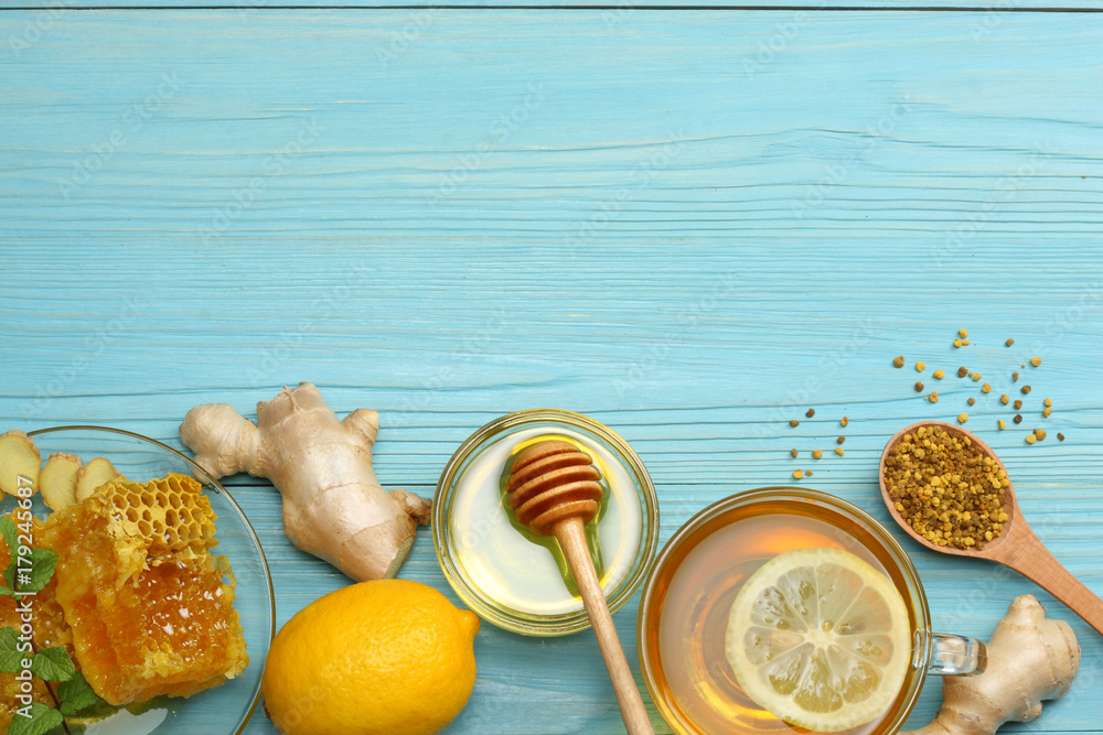 healthy background. honey, honeycomb, lemon, tea, ginger on blue wooden table. Top view with copy space healthy background. honey, honeycomb, lemon, tea, ginger on blue wooden table. Top view with copy space