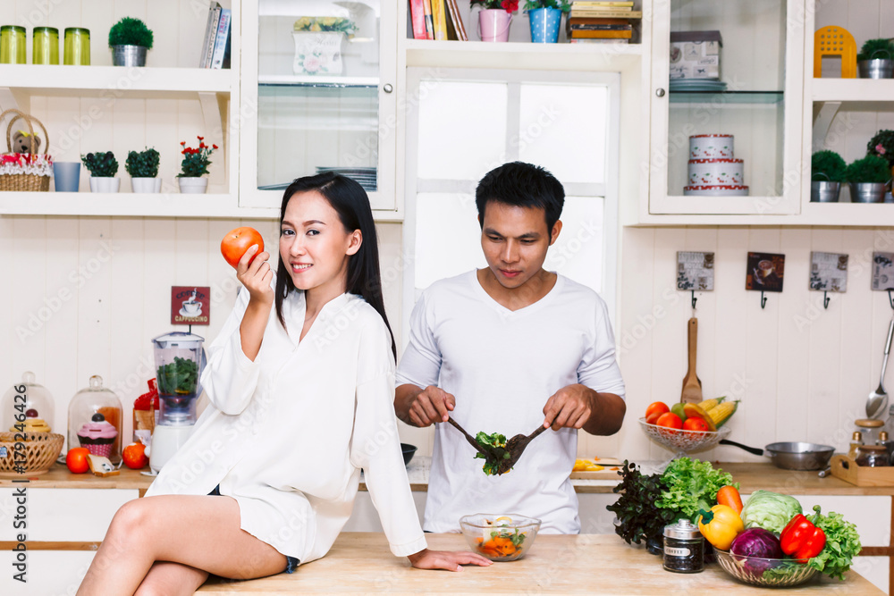 Young couple cooking food in the kitchen