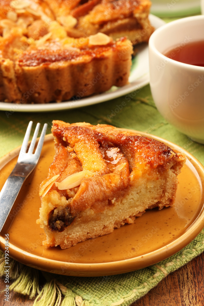Freshly baked hot apple pie served on a yellow plate with tea Freshly baked hot apple pie served on a yellow plate with tea