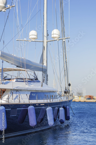 Boat luxury side docked on marine harbor port with clean sky background