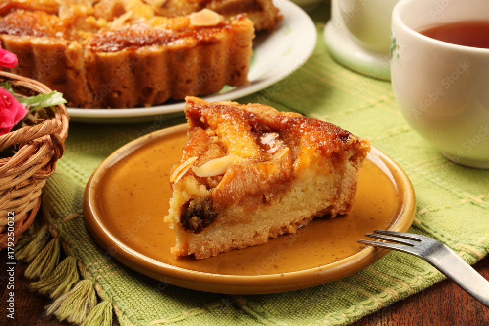 Freshly baked hot apple pie served on a yellow plate with tea Freshly baked hot apple pie served on a yellow plate with tea