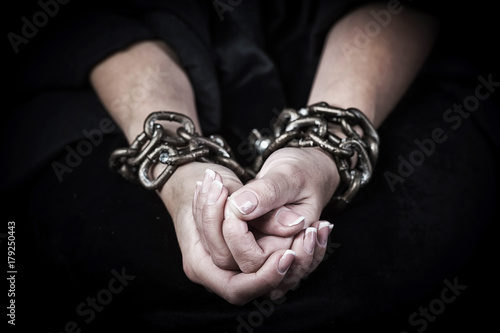 Hands in chains. Woman prisoner concept.