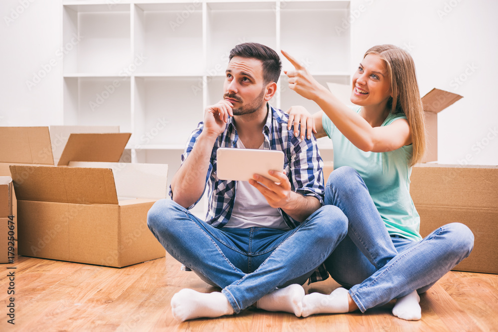 Young couple is moving in their new home. Young couple is moving in their new home.