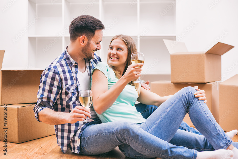 Young couple is moving to their new home. It's time for celebration. Young couple is moving to their new home. It's time for celebration.
