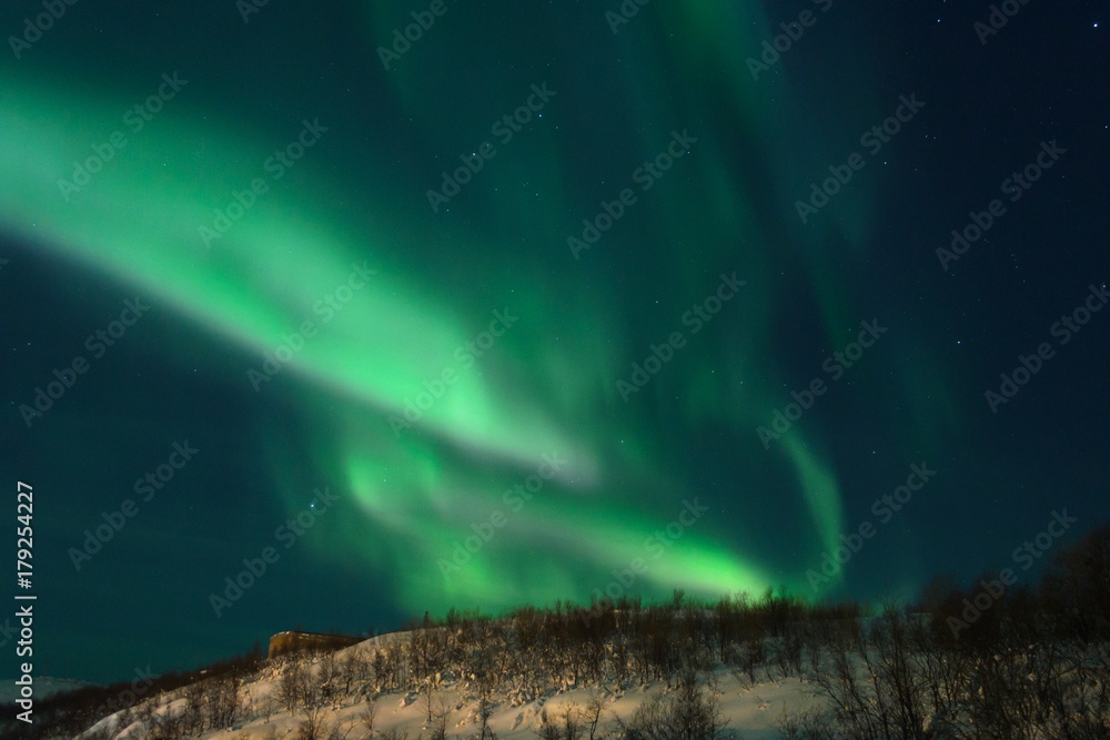 Northern lights,Aurora in the night above the hills.