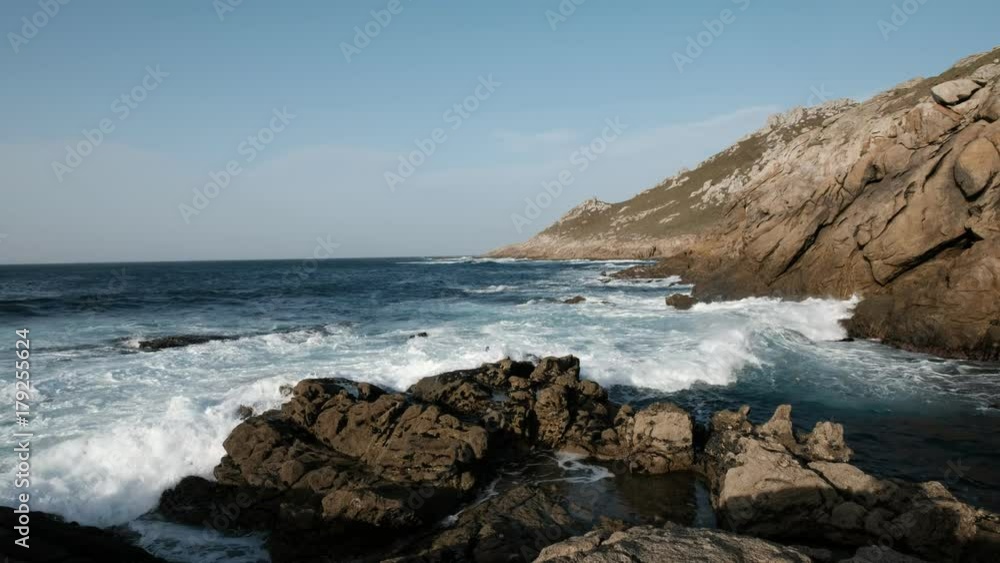 waves break against rocks waves break against rocks