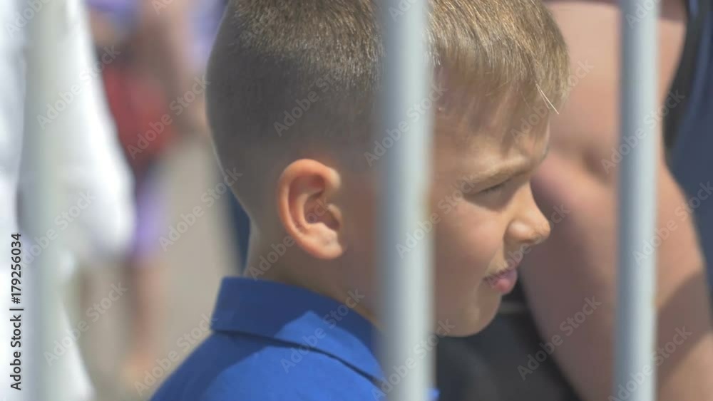 Teenager stands on the spot in the street and looks forward Teenager stands on the spot in the street and looks forward