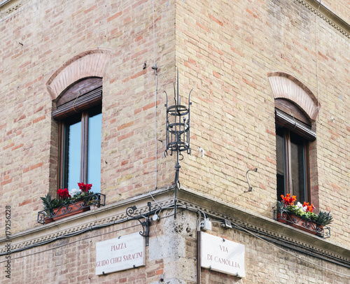 Street corner building facade in Siena, Tuscany, Italy photo