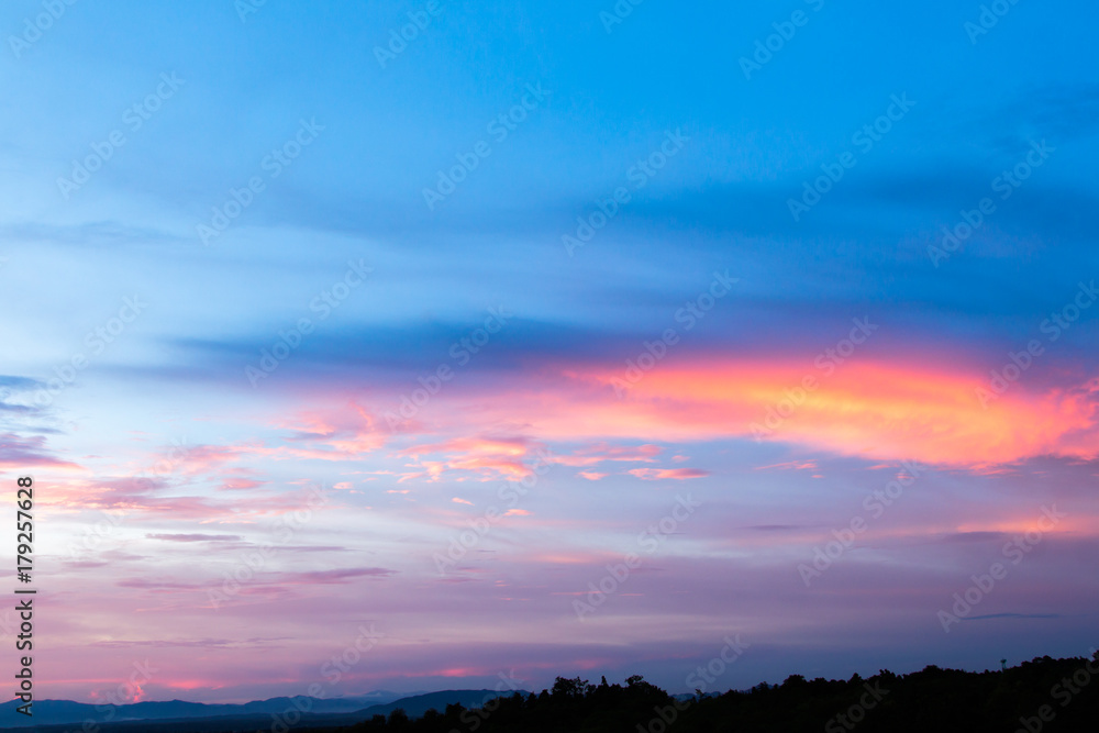 colorful dramatic sky with cloud at sunset.