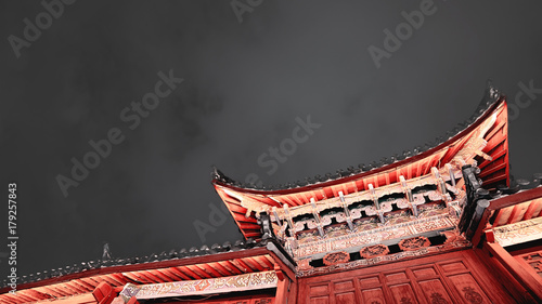 Traditional Chinese roof  in the Old Town of Lijiang at night, toned image with copy space, China.