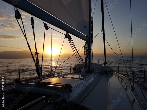 Mast of the yacht at sunrise at sea