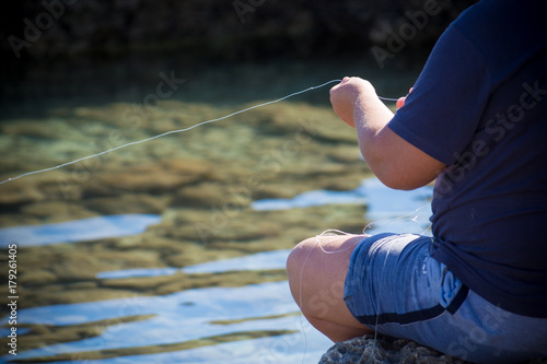 man fishing with a fishing line photo