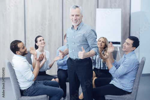 Confident male person standing in the middle of circle