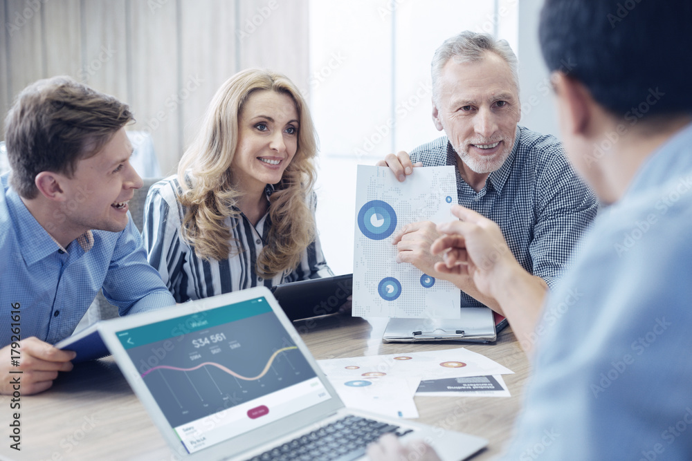 Fototapeta premium Attractive female office worker sitting between her colleagues