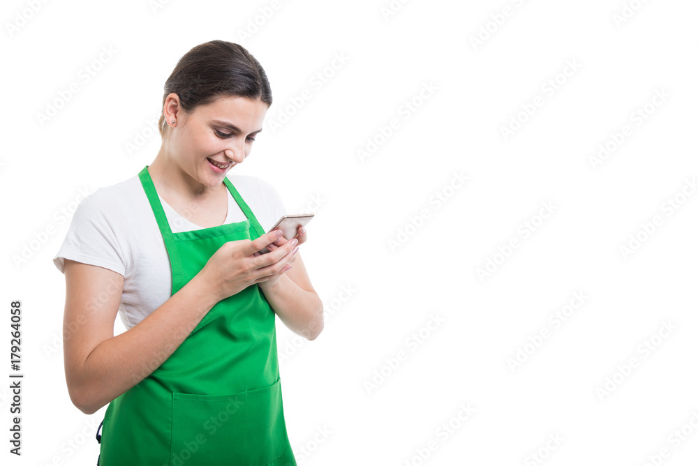 Happy female seller texting on cellphone Happy female seller texting on cellphone