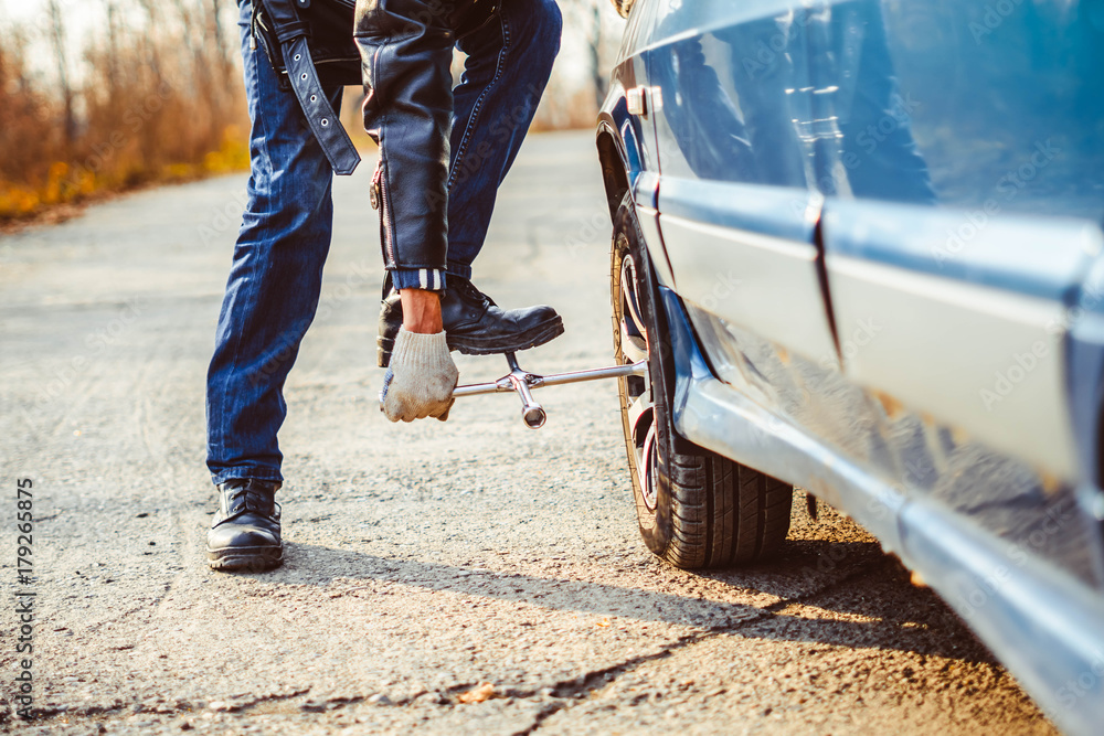 man changing wheel on a car