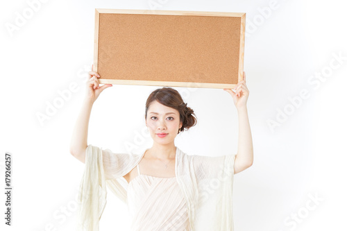 woman in dress having a cork board