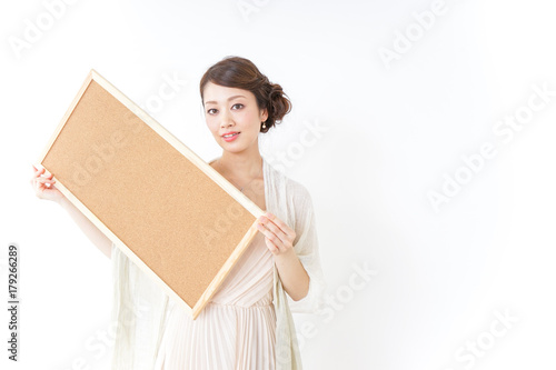 woman in dress having a cork board