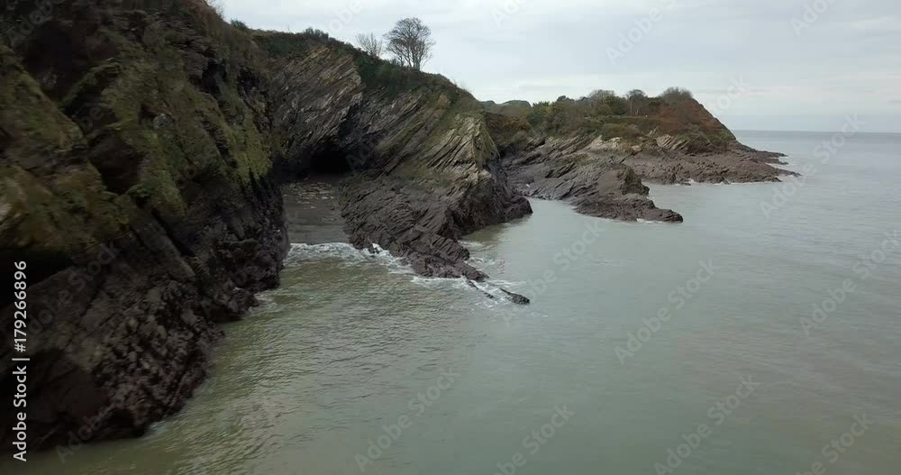 Aerial view looking out over a rocky coastline and cliffs Aerial view looking out over a rocky coastline and cliffs