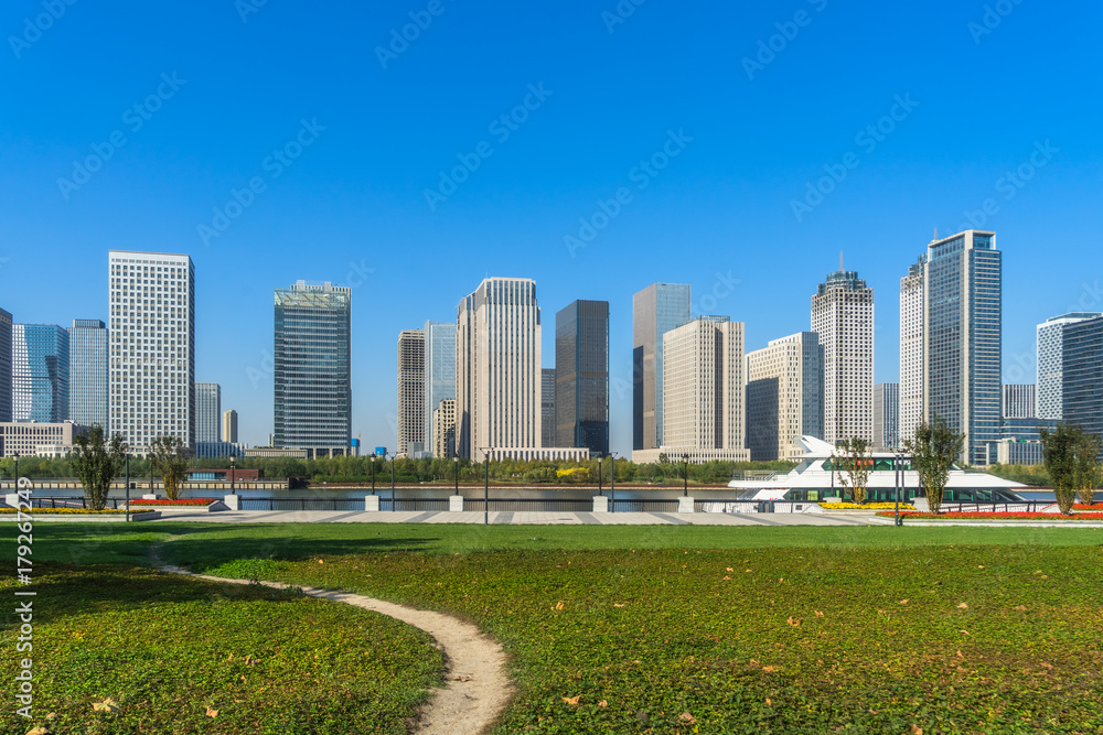 green lawn with city skyline background, tianjin china.