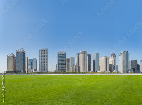 green lawn with city skyline background, tianjin china.
