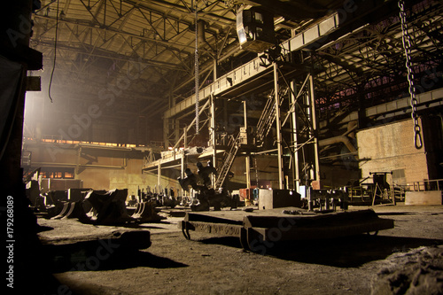 Dark abandoned rusted ruined industrial interior at night. Voronezh excavator plant