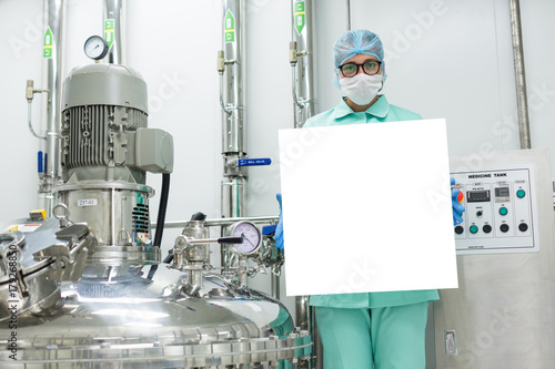 scientist is holding empty banner near compressor tank photo