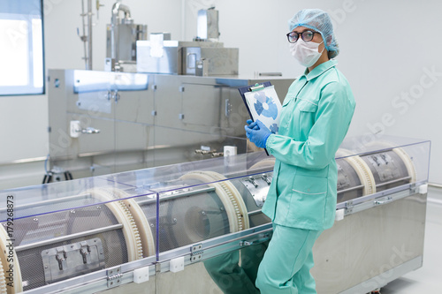 scientist standing near centrifuge photo