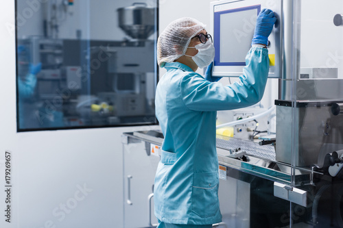 Wallpaper Mural factory worker configures control panel Torontodigital.ca