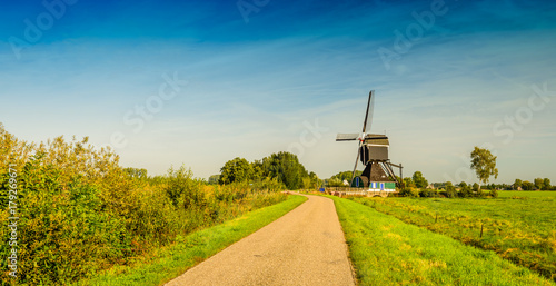 Historic wooden hollow post mill from 1762 in a Dutch rural landscape