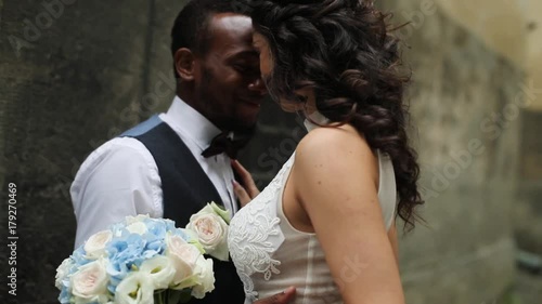 Happy african american groom and caucasian bride.