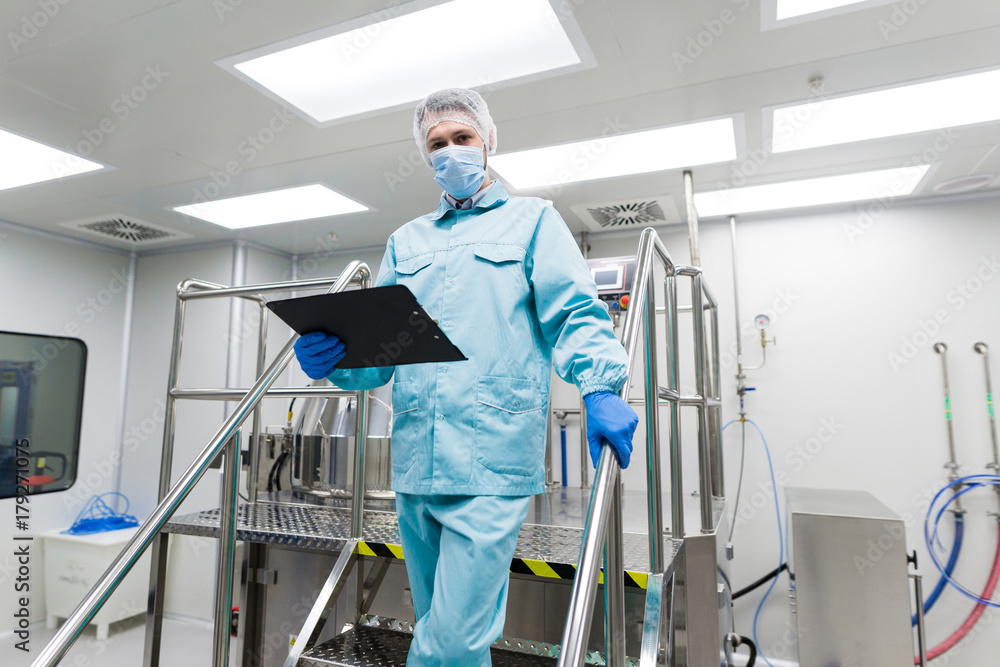 plant picture, scientist is standing on ladder in laboratory, checking readings plant picture, scientist is standing on ladder in laboratory, checking readings