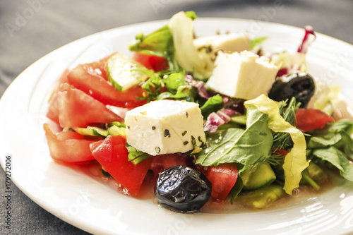 Greek salad with fresh vegetables, feta cheese and olives