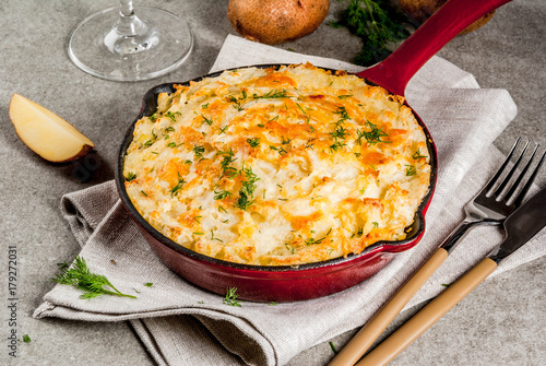 Skillet Shepherd's Pie, british casserole in cast iron pan, with minced meat, mashed potatoes and vegetables, on gray stone background, copy space top view