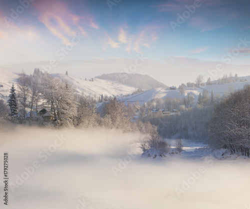 Splendid winter sunrise in foggy mountains. © Andrew Mayovskyy