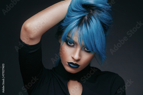 Portrait of a young woman with blue color hair