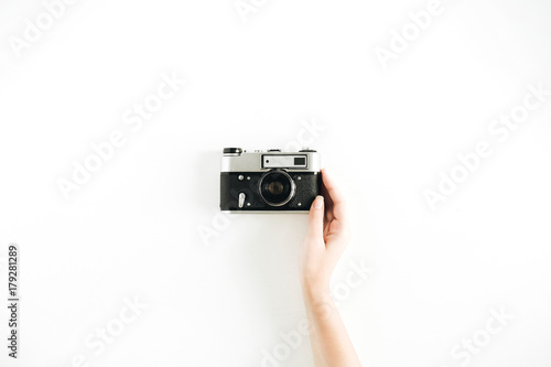Retro photo camera in woman hand. Minimal hipster flat lay.