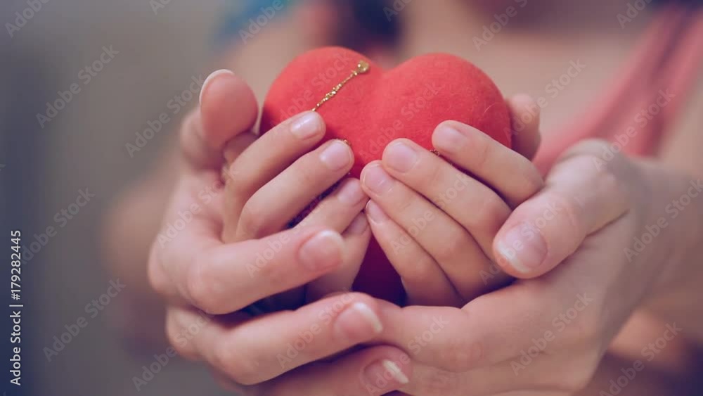 Little girl and her mother holding a heart Little girl and her mother holding a heart