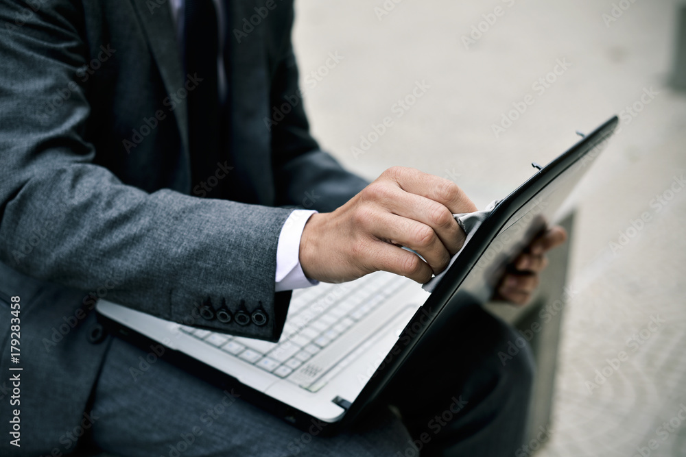 businessman cleaning the screen of a laptop businessman cleaning the screen of a laptop